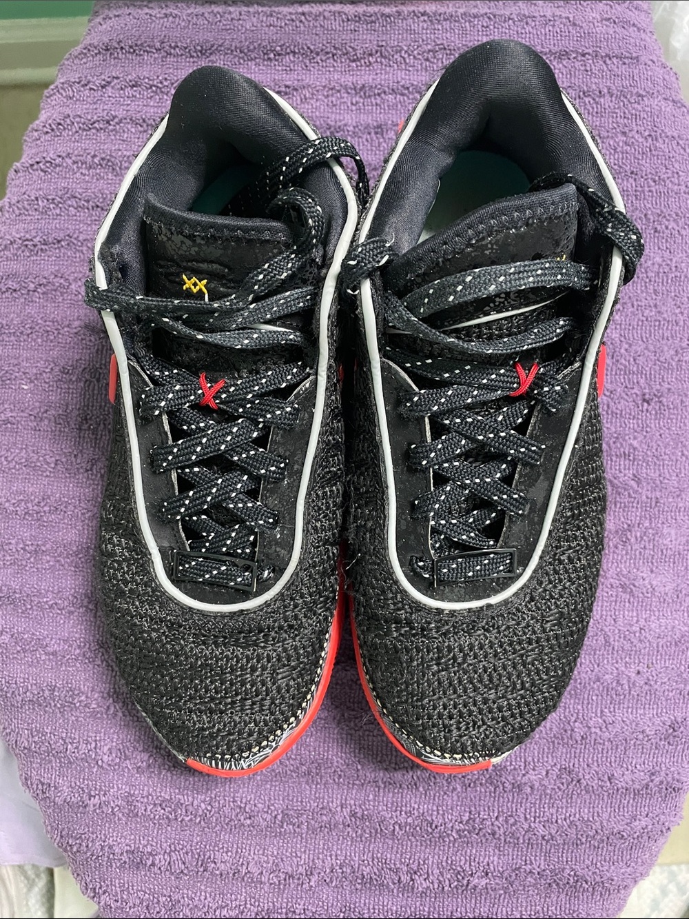 Nike Black Knit Sneakers with Gold Swoosh and Red Accents